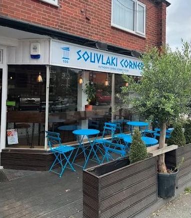 Souvlaki Corner Armley shopfront with its blue café tables